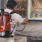 Contractor using the Titan Impact X 120 backpack sprayer indoors.