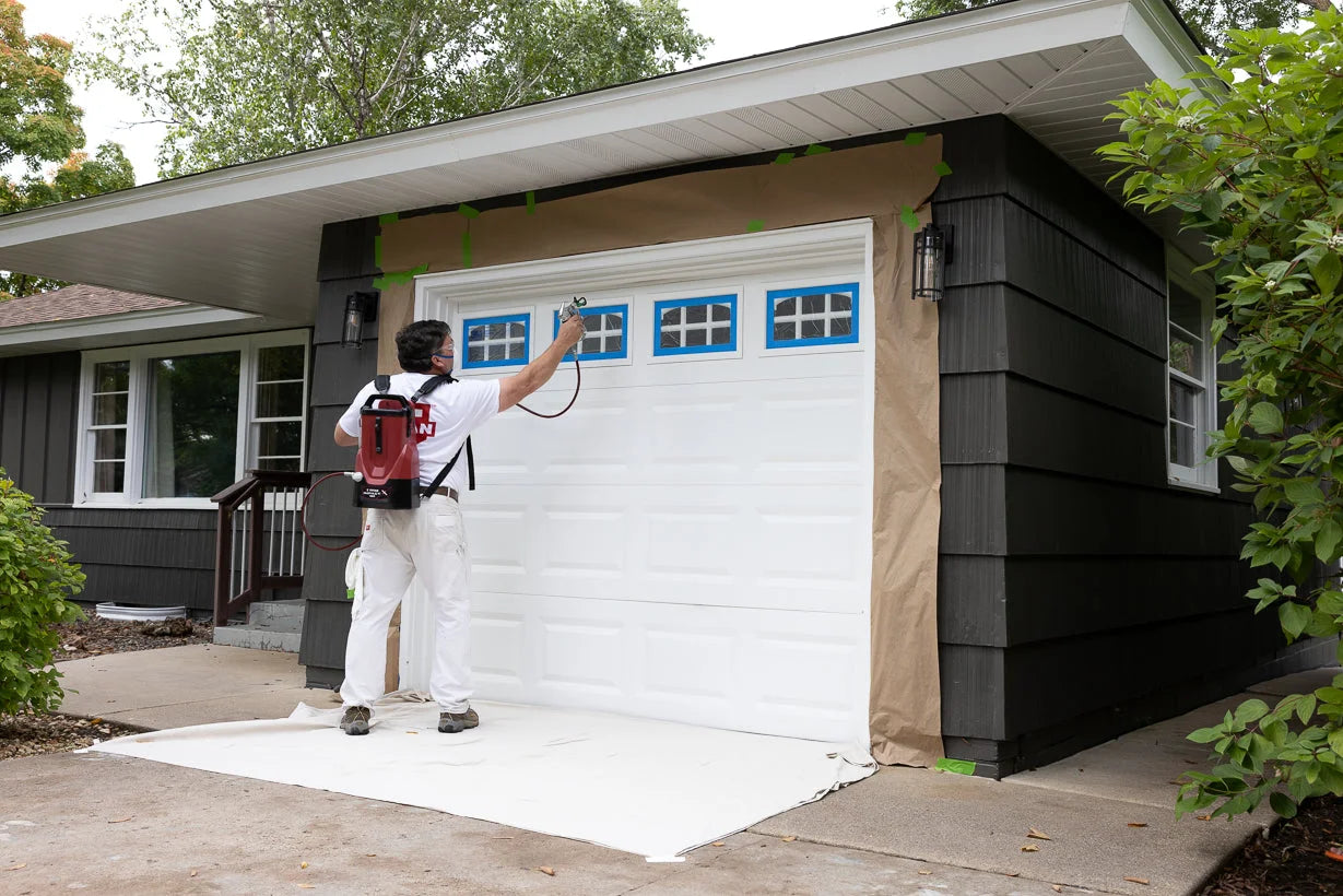 Titan Impact X 120 backpack sprayer used for exterior house painting.